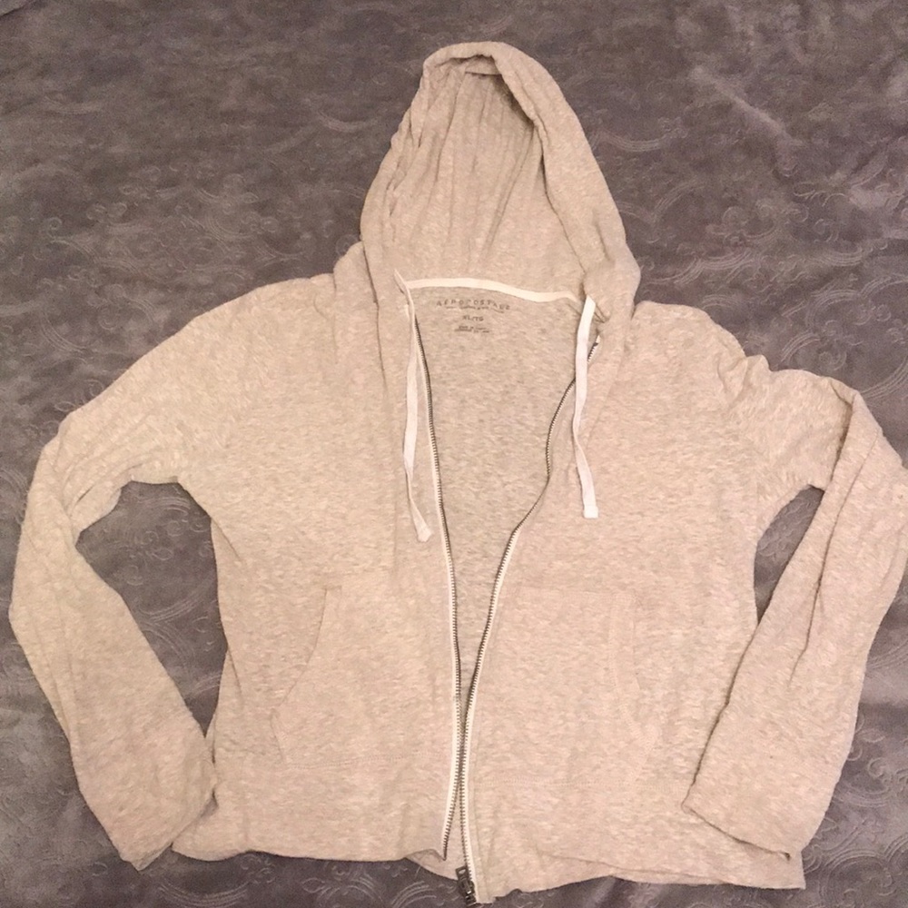 Cream hoodie with zipper.